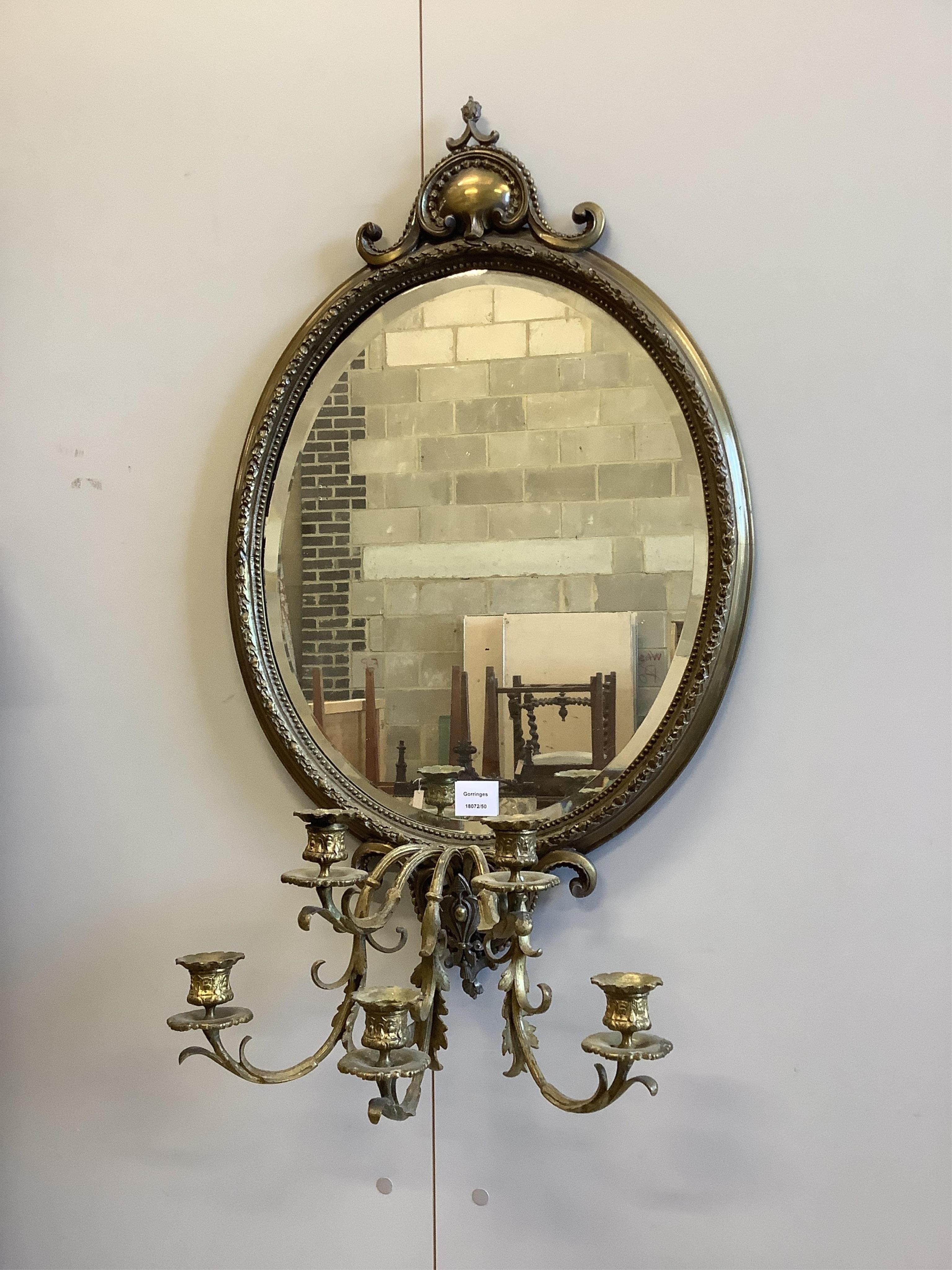 An early 20th century oval brass girandole wall mirror, width 52cm, height approx. 90cm